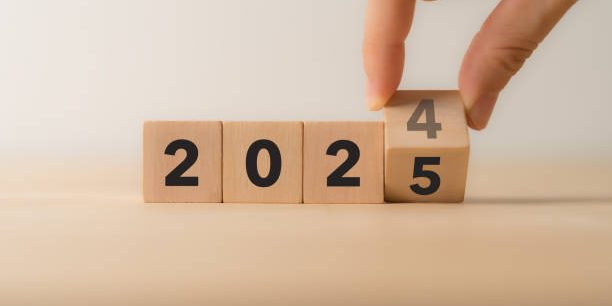 Starting new year 2025. Flipping of 2024 to 2025 on wooden cube blocks. Beginning and start of the new year 2024. Preparation for new year ,life, business, plan, goals, target and strategy concept.